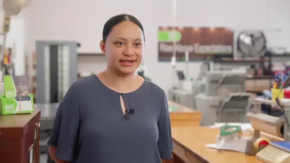 Maxine in the Ready Press workshop, presses behind her